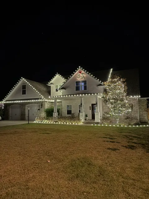 White holiday lights outlining a two-story home