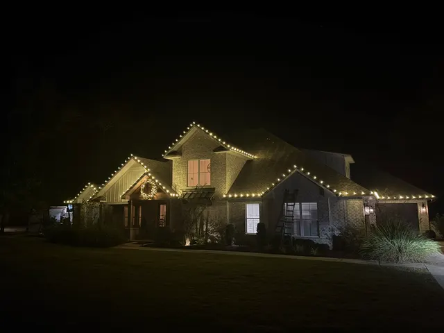 Holiday lighting along the roof and dormers of a home