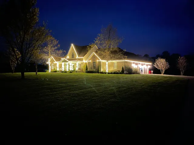 Wide view of a home decorated with warm Christmas lights