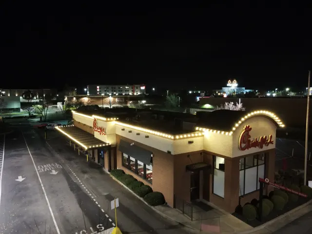 Warm Christmas lights tracing a commercial roofline and canopy