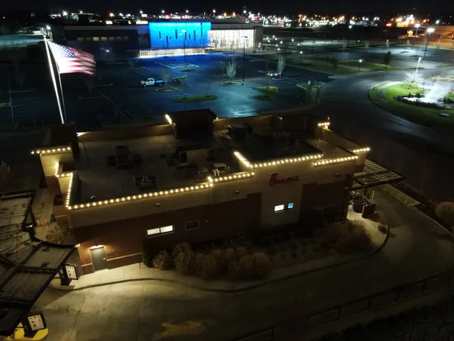 Elevated view of holiday lights along a commercial building roof