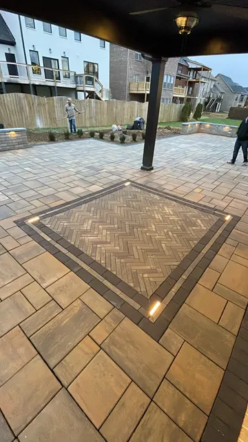 Herringbone paver inlay beneath a covered patio
