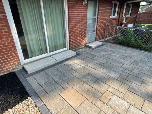 Paver patio meeting a sliding door and back steps
