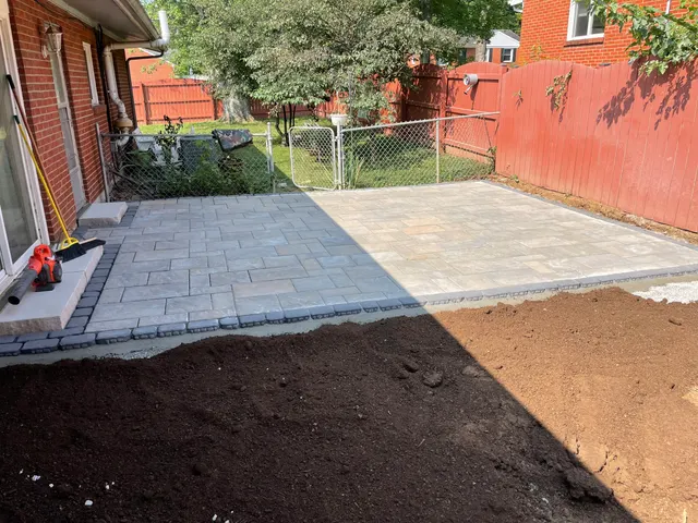 Finished patio surface and surrounding yard preparation