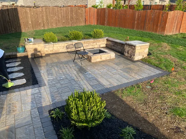 Paver patio, masonry seating wall and planted borders
